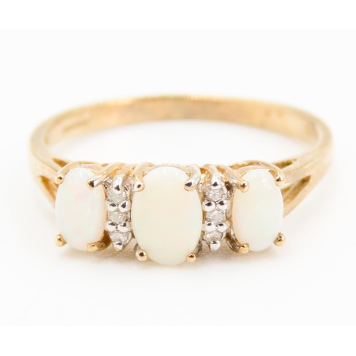 241 - Three Stone Opal and Diamond Set Ladies Ring Mounted in 9 Carat Yellow Gold Ring Size N