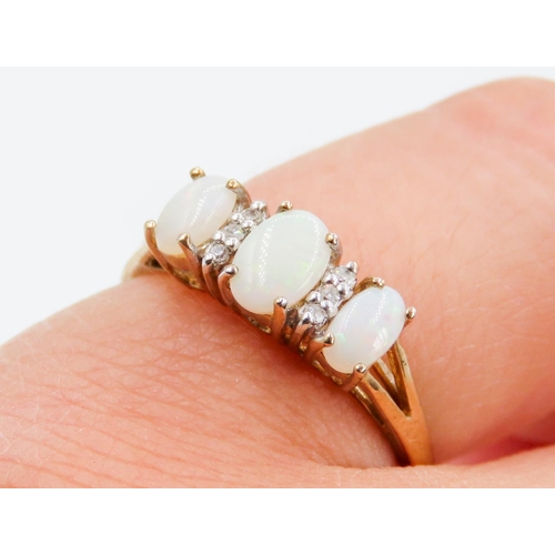 241 - Three Stone Opal and Diamond Set Ladies Ring Mounted in 9 Carat Yellow Gold Ring Size N