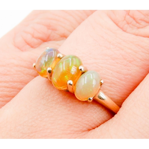 288 - Opal Three Stone Ring Basket Set Mounted in 9 Carat Yellow Gold Ring Size O