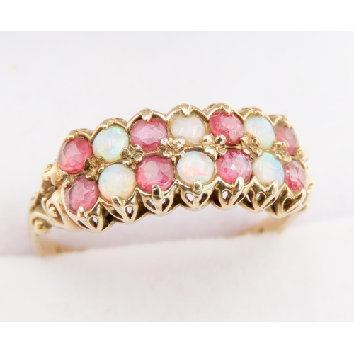 301 - Finely Detailed Opal and Ruby Set Fourteen Stone Ring Mounted in 9 Carat Yellow Gold Ring Size P