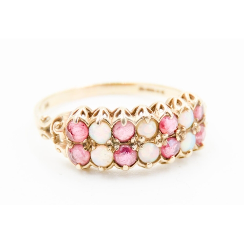 301 - Finely Detailed Opal and Ruby Set Fourteen Stone Ring Mounted in 9 Carat Yellow Gold Ring Size P