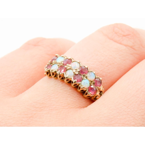 301 - Finely Detailed Opal and Ruby Set Fourteen Stone Ring Mounted in 9 Carat Yellow Gold Ring Size P