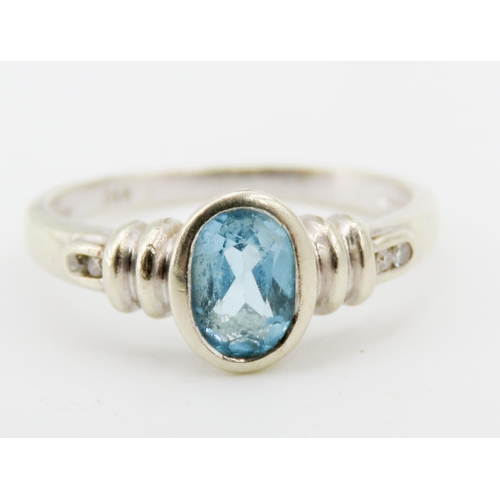 325 - Oval Bezel Set Sky Blue Topaz Ring Mounted in 9 Carat White Gold Further Diamond Set to Shoulders Ri... 