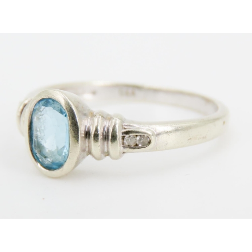 325 - Oval Bezel Set Sky Blue Topaz Ring Mounted in 9 Carat White Gold Further Diamond Set to Shoulders Ri... 