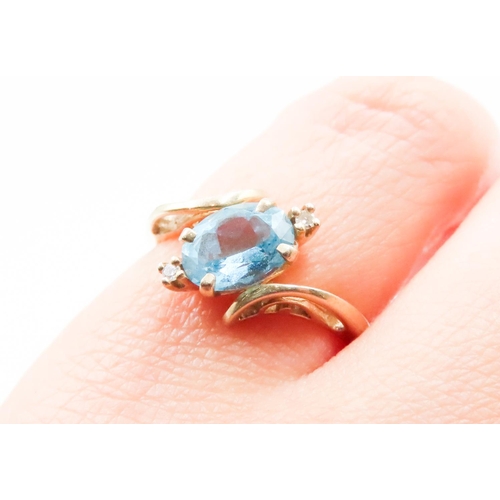 583 - Oval Cut Blue Topaz and Diamond Set Ladies Wrap Around Form Ring Mounted in 14 Carat Yellow Gold Rin... 