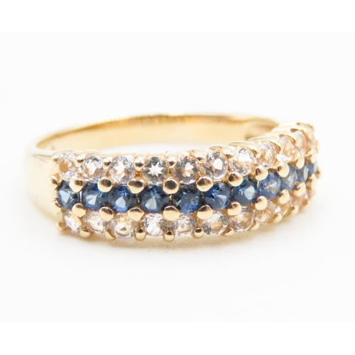 591 - Sapphire and White Topaz Set Three Row Ring Mounted in 14 Carat Yellow Gold Ring Size S and a Half