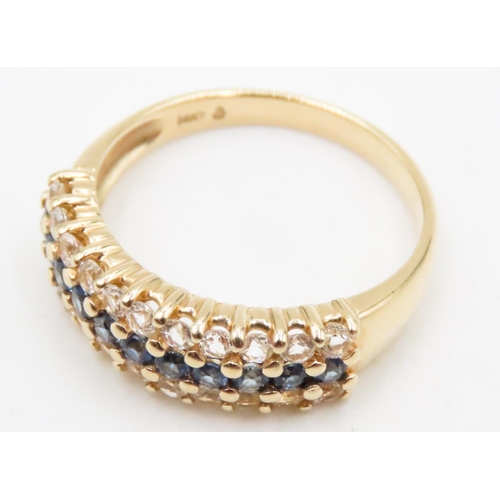 591 - Sapphire and White Topaz Set Three Row Ring Mounted in 14 Carat Yellow Gold Ring Size S and a Half