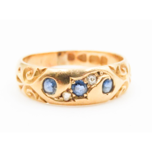 631 - Sapphire Three Stone Ring with Further Diamond Inset Mounted in 18 Carat Yellow Gold incised Detail ... 