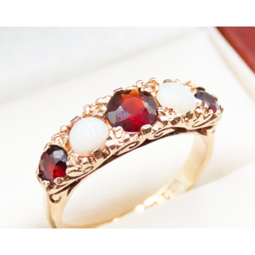 636 - Red Garnet and Opal Set Ring Attractively Detailed Mounted in 9 Carat Yellow Gold Ring Size K