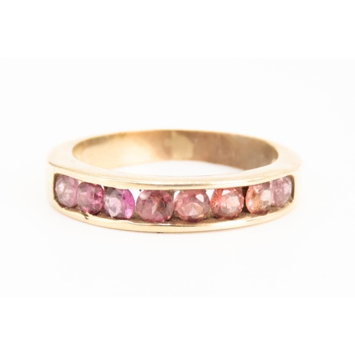 69 - Pink Tourmaline Channel Set Half Eternity Ring Mounted in 9 Carat Yellow Gold Ring Size N and a Half