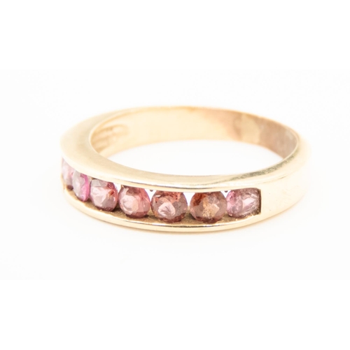 69 - Pink Tourmaline Channel Set Half Eternity Ring Mounted in 9 Carat Yellow Gold Ring Size N and a Half