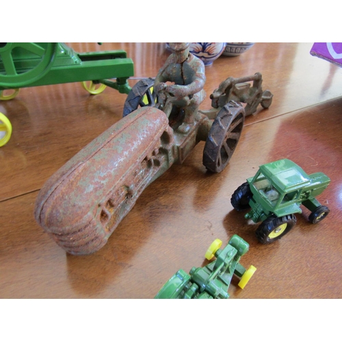 856 - John Deere Cast Iron Tractors One with Plough Four Pieces in Lot