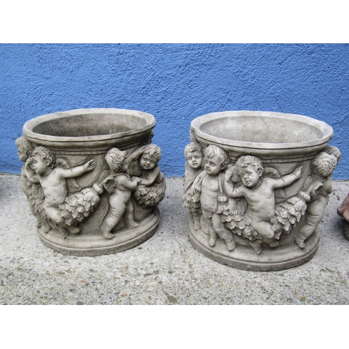 2091 - Composite Stone Pair of Circular Planters with Cherub Motif Decoration Each Approximately 12 Inches ... 