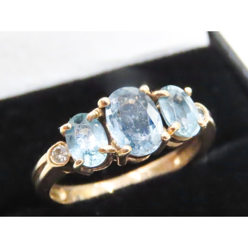 117 - Three Stone Blue Topaz Ring further Diamonds Set to Shoulders Mounted in 9 Carat Yellow Gold Ring Si... 