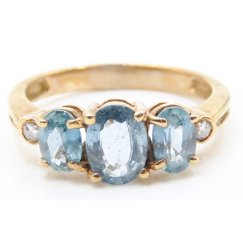 117 - Three Stone Blue Topaz Ring further Diamonds Set to Shoulders Mounted in 9 Carat Yellow Gold Ring Si... 