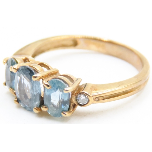 117 - Three Stone Blue Topaz Ring further Diamonds Set to Shoulders Mounted in 9 Carat Yellow Gold Ring Si... 