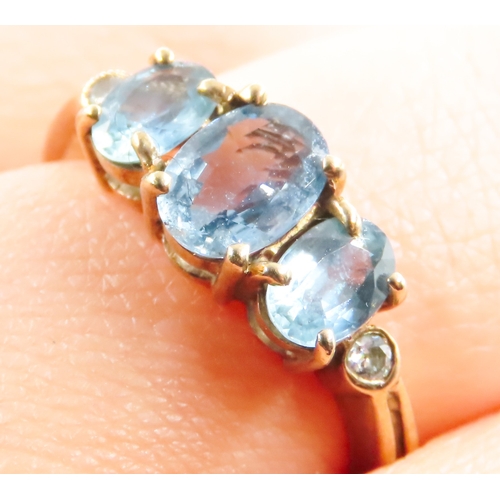 117 - Three Stone Blue Topaz Ring further Diamonds Set to Shoulders Mounted in 9 Carat Yellow Gold Ring Si... 