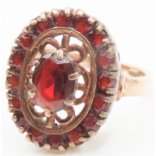 21 - Attractively Detailed Red Garnet Set Filigree Motif Ring Mounted in 9 Carat Yellow Gold Ring Size J