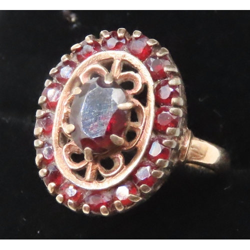 21 - Attractively Detailed Red Garnet Set Filigree Motif Ring Mounted in 9 Carat Yellow Gold Ring Size J