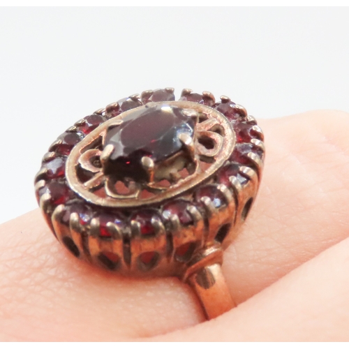 21 - Attractively Detailed Red Garnet Set Filigree Motif Ring Mounted in 9 Carat Yellow Gold Ring Size J