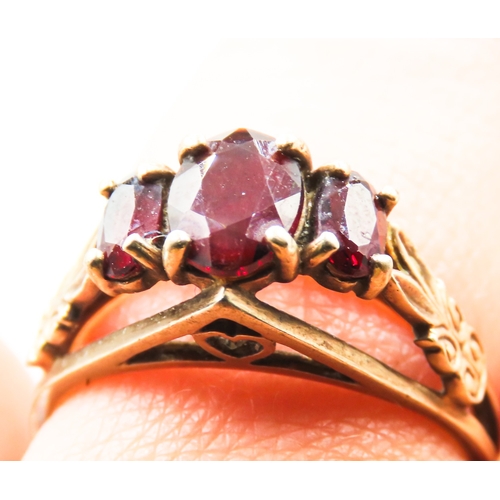 237 - Finely Detailed Red Garnet Three Stone Ring Set in 9 Carat Yellow Gold Ring Size N