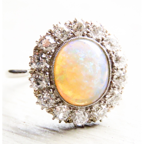 259 - Opal Centre Stone Ring with Fourteen Diamond Set Halo Surround Mounted in Platinum Ring Size P