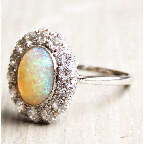 259 - Opal Centre Stone Ring with Fourteen Diamond Set Halo Surround Mounted in Platinum Ring Size P