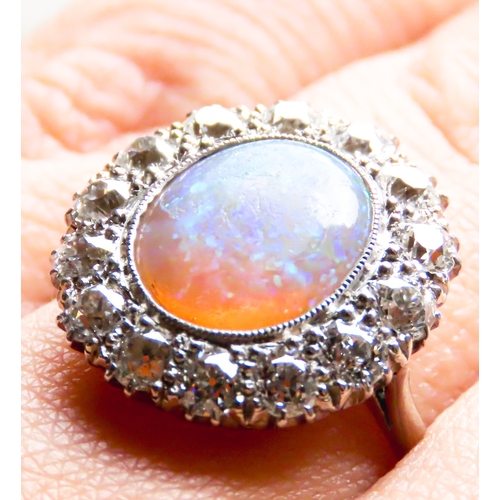 259 - Opal Centre Stone Ring with Fourteen Diamond Set Halo Surround Mounted in Platinum Ring Size P