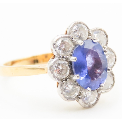 28 - Tanzanite Eight Claw Set Centre Stone Ring with Diamond Halo Set Surround Mounted on 18 Carat Yellow... 