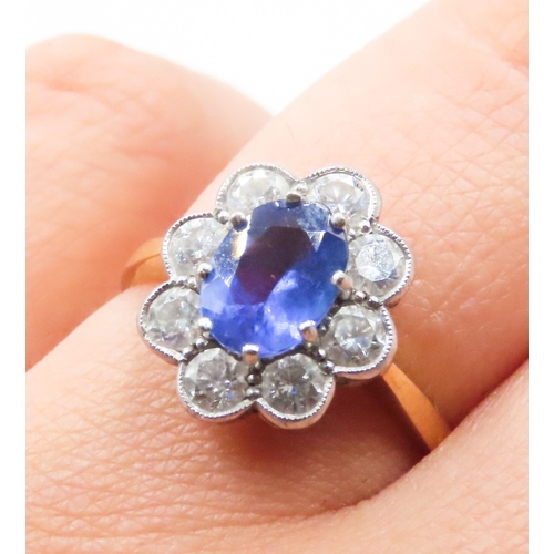 28 - Tanzanite Eight Claw Set Centre Stone Ring with Diamond Halo Set Surround Mounted on 18 Carat Yellow... 