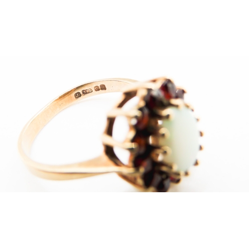 291 - Opal Centre Stone Ring with Red Garnet Set Halo Surround Mounted in 9 Carat Yellow Gold Ring Size K