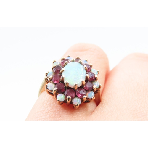 375 - Opal Centre Stone Ring with Further Ruby and Opal Halo Setting Mounted in 9 Carat Yellow Gold Ring S... 