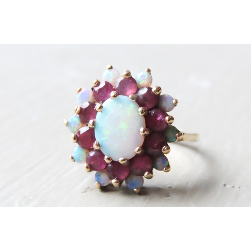 375 - Opal Centre Stone Ring with Further Ruby and Opal Halo Setting Mounted in 9 Carat Yellow Gold Ring S... 