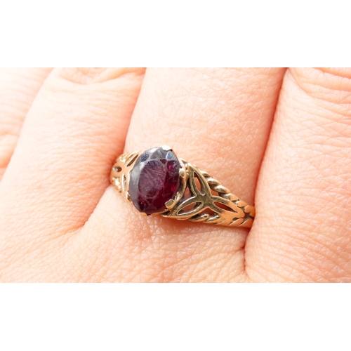 478 - Red Garnet Single Stone Ring Celtic Motif Mounted in 9 Carat Yellow Gold Ring Size U and a Half