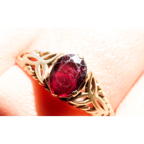 478 - Red Garnet Single Stone Ring Celtic Motif Mounted in 9 Carat Yellow Gold Ring Size U and a Half