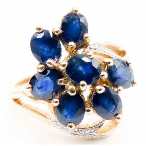 597 - Sapphire Set Seven Stone Floral Form Ring Set in 9 Carat Yellow Gold with Further Diamonds to Settin... 