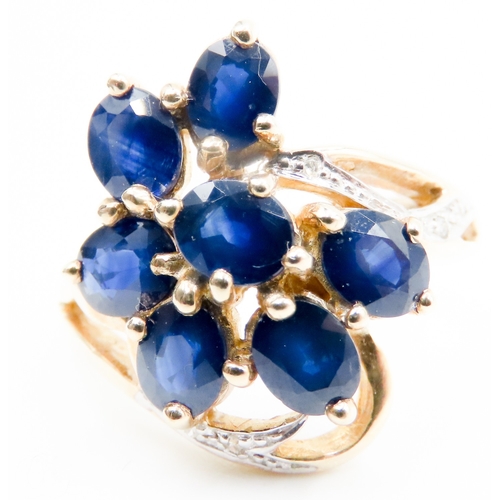 597 - Sapphire Set Seven Stone Floral Form Ring Set in 9 Carat Yellow Gold with Further Diamonds to Settin... 