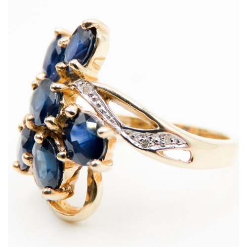 597 - Sapphire Set Seven Stone Floral Form Ring Set in 9 Carat Yellow Gold with Further Diamonds to Settin... 