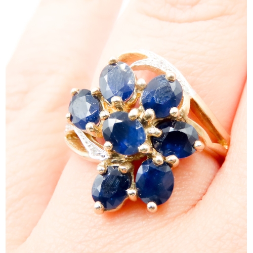 597 - Sapphire Set Seven Stone Floral Form Ring Set in 9 Carat Yellow Gold with Further Diamonds to Settin... 