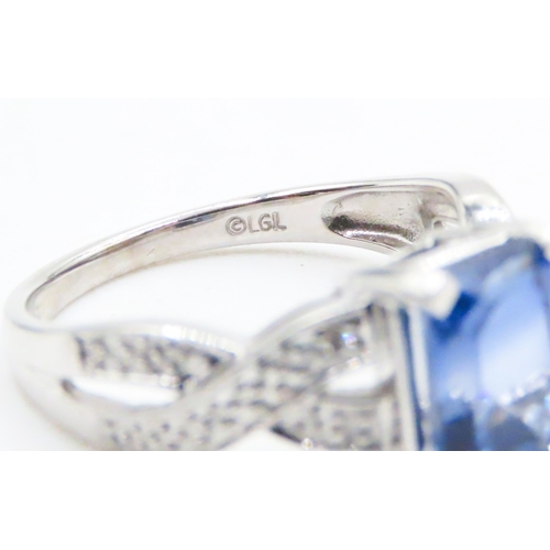 88 - Emerald Cut Tanzanite Four Claw Set Ring Braid Motif Band Mounted in 10 Carat White Gold Ring Size O