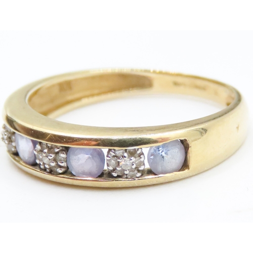 98 - Pale Tanzanite and Diamond Cluster Channel Set Ring Mounted in 9 Carat Yellow Gold Ring Size N