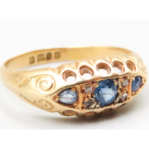 121 - Sapphire Three Stone Ring with Diamond Insets Mounted in 18 Carat Yellow Gold Ring Size L