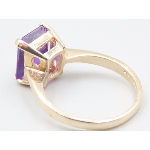 140 - Emerald Cut Amethyst Four Claw Set Single Stone Ring Mounted in 9 Carat Yellow Gold Ring Size M and ... 