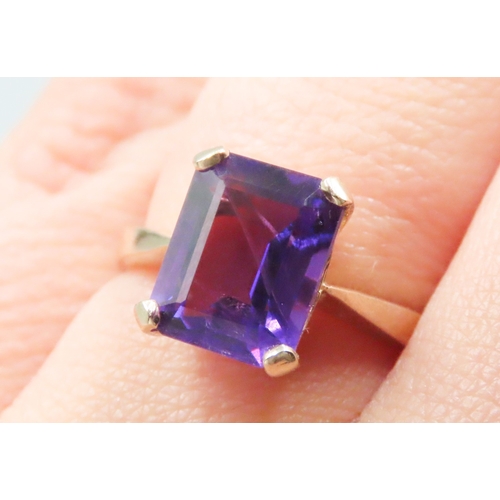 140 - Emerald Cut Amethyst Four Claw Set Single Stone Ring Mounted in 9 Carat Yellow Gold Ring Size M and ... 