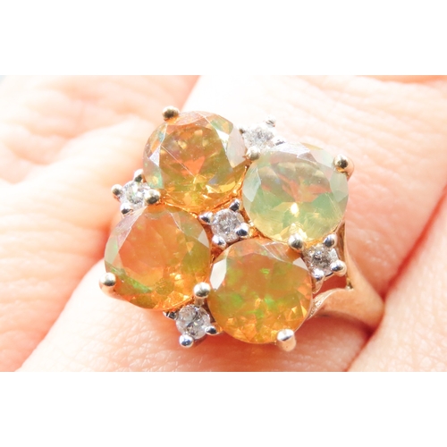 159 - Mexican Opal Four Stone Set Ring with Further Diamond Inset Mounted in 9 Carat Yellow Gold Ring Size... 