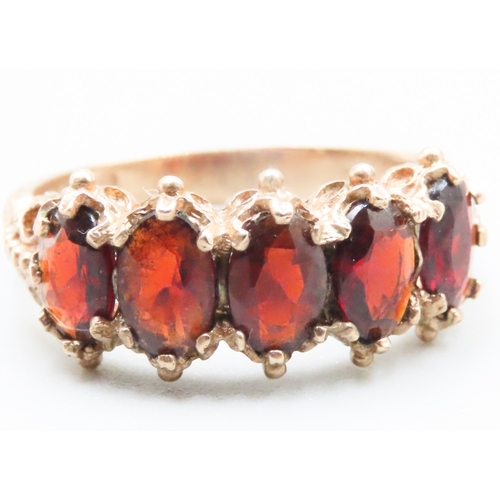 230 - Red Garnet Set Five Stone Ring Finely Detailed Mounted in 9 Carat Yellow Gold Ring Size P