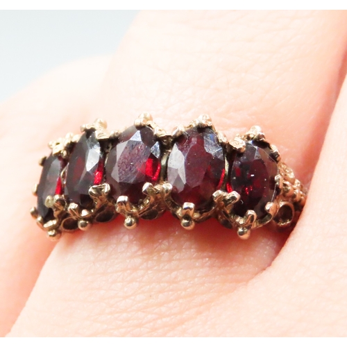 230 - Red Garnet Set Five Stone Ring Finely Detailed Mounted in 9 Carat Yellow Gold Ring Size P