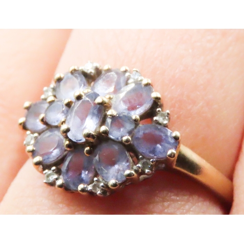 232 - Amethyst and Diamond Set Ladies Floral Form Cluster Ring Mounted in 9 Carat Yellow Gold Ring Size R