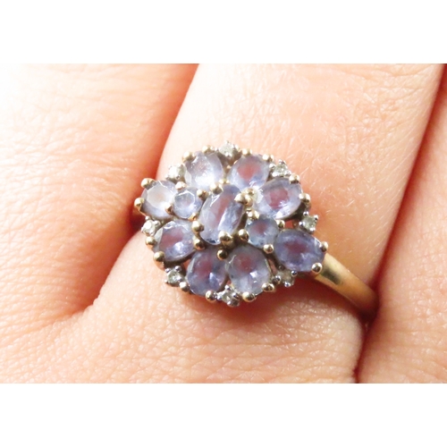 232 - Amethyst and Diamond Set Ladies Floral Form Cluster Ring Mounted in 9 Carat Yellow Gold Ring Size R