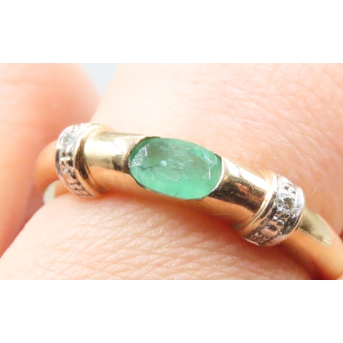 26 - Oval Cut Emerald Set Buckle Form Ring with Further Diamond Inset Mounted in 9 Carat Yellow Gold Ring... 